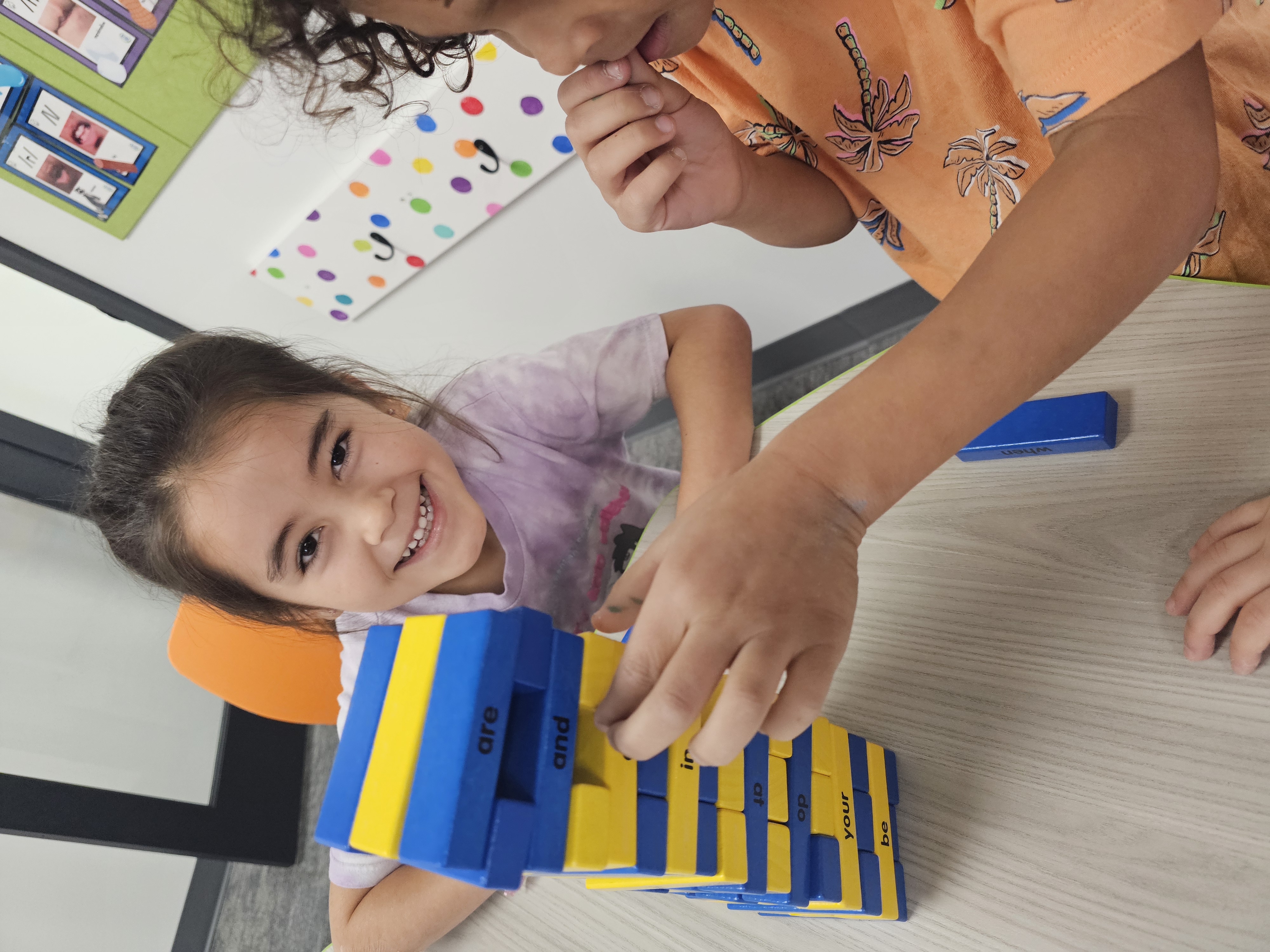 Student practicing reading with letter-block phonics